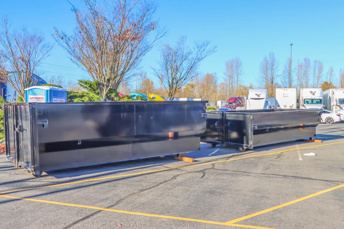 Professional dumpster rental service with roll-off container on residential driveway in Hartselle